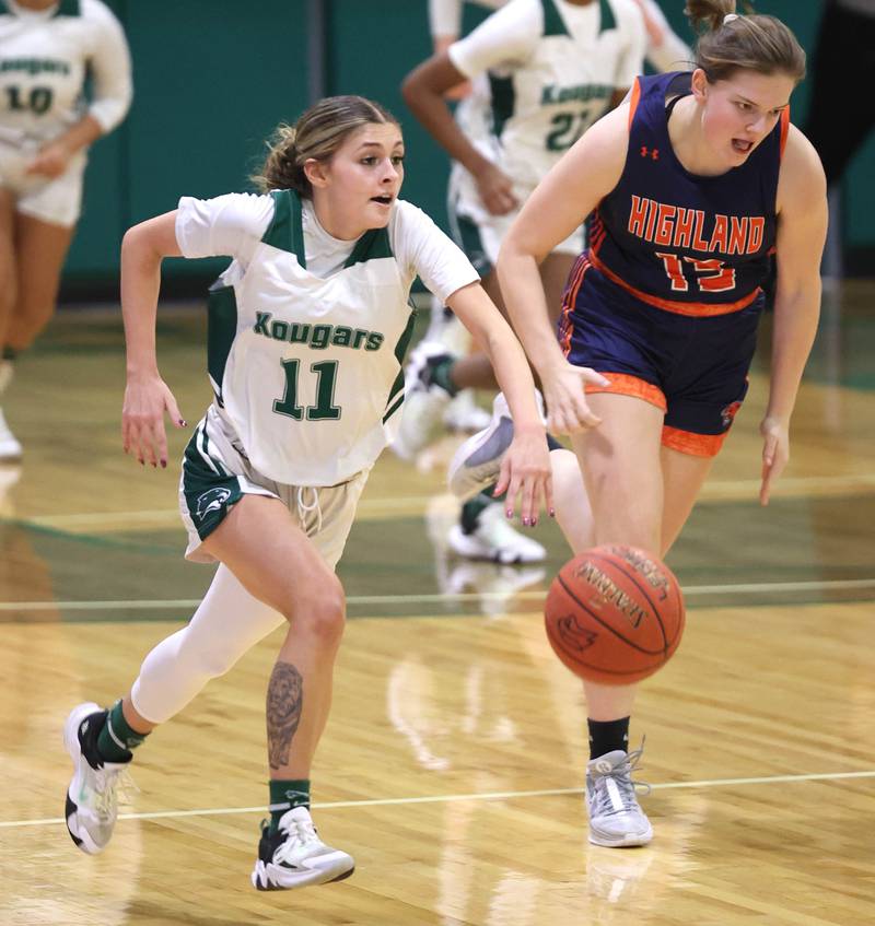 Kishwaukee College's Kira Klapprodt pushes the ball ahead of Highland Community College's Marie-Louise de Jong during their game Thursday, Jan. 11, 2024, at Kishwaukee College in Malta.