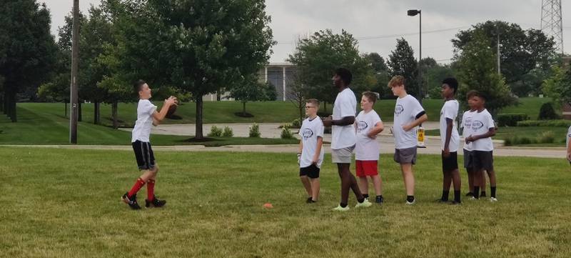 NIU defensive back Devin Lafayette works on drills with a camper on Sunday, July 24, 2022 at the Youth Pride Foundation Skills and Drills Football camp.