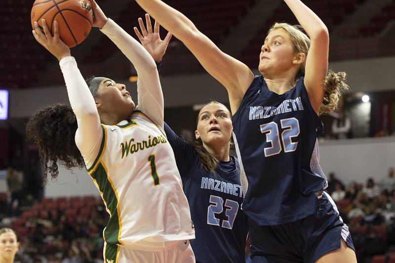Waubonsie Valley’s Arianna Garcia puts up a shot against Nazareth Academy’s Stella Sakalas (right) and Danielle Scully Friday, March 1, 2024 in the girls basketball 4A state semifinal at CEFCU Arena in Normal.