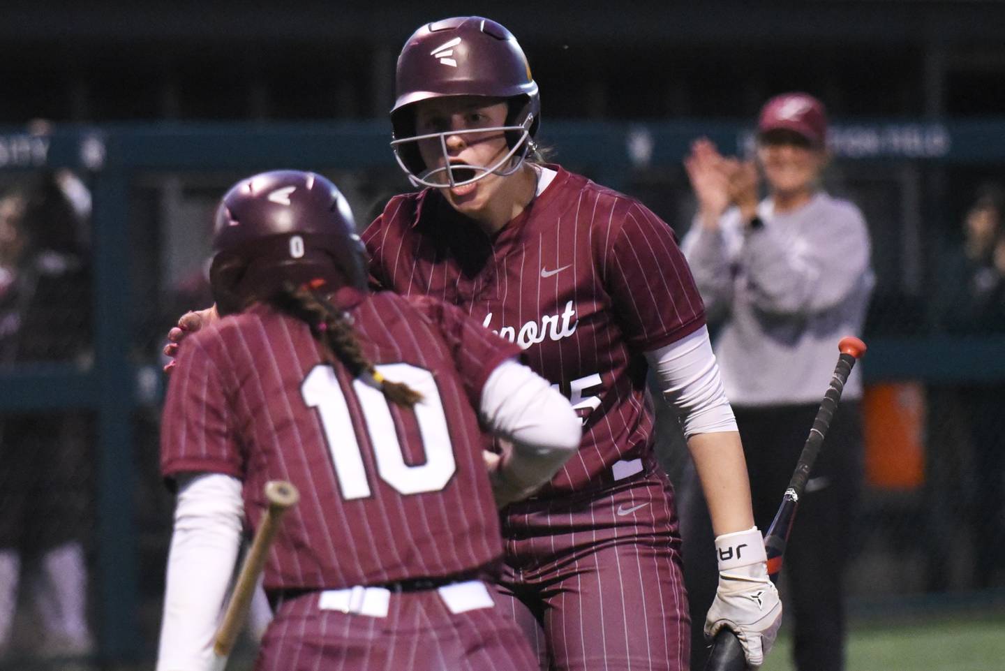 Lockport's Liliana Janeczko congratulates teammate Addison Way (10) while head coach Marissa Chovanec applauds in the background after Way's run in the Class 4A Illinois Wesleyan Supersectional against Bradley-Bourbonnais Monday, June 9, 2025.