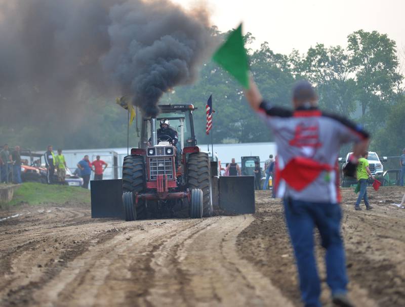 Jake Koch of Ladd drives his International Harvestor 1066 in the tractor pull at the Ogle County Fair on Thursday, July 31, 2025.