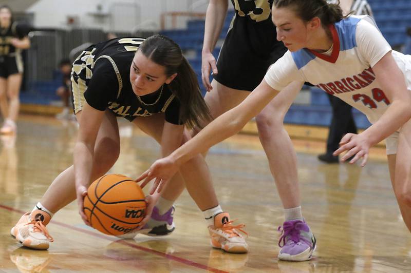 Marian Central's Juliette Huff tries to come up with a loose ball before Rockford Christian's Shea Ludwig grabs the ball during a nononference basketball game on Monday, Feb. 10, 2025, at Marian Central High School  in Woodstock.