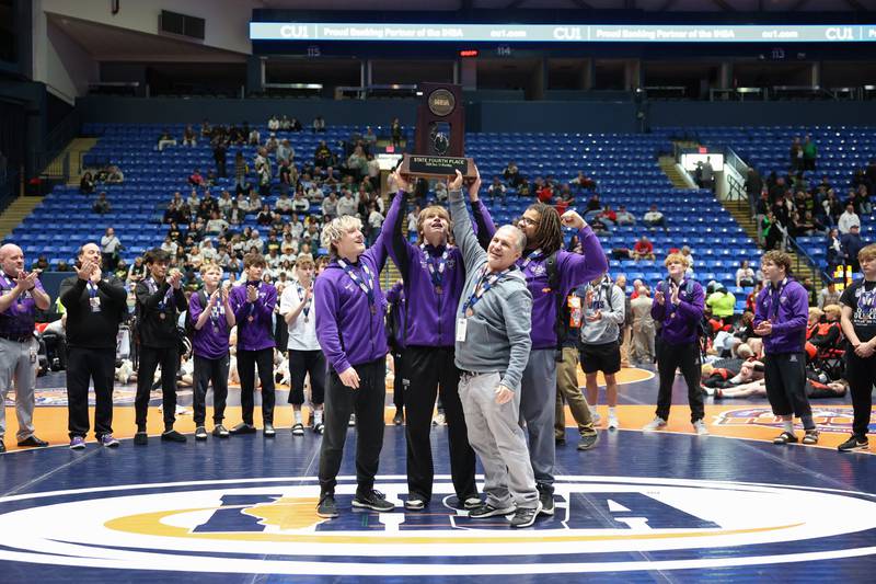 Dixon's team hoists the IHSA Class 1A Dual Team State third place trophy on Saturday, Feb. 28, 2026.