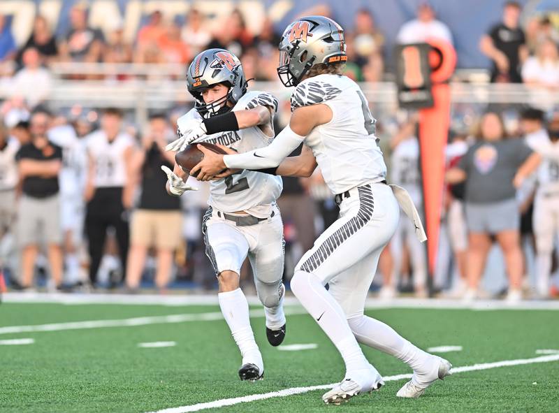 Minooka's Zane Caves hands the off to Ty Couch during a non-conference game against Joliet Central on Friday, Sep 13, 2024 at Joliet. (Dean Reid for Shaw Local News Network)