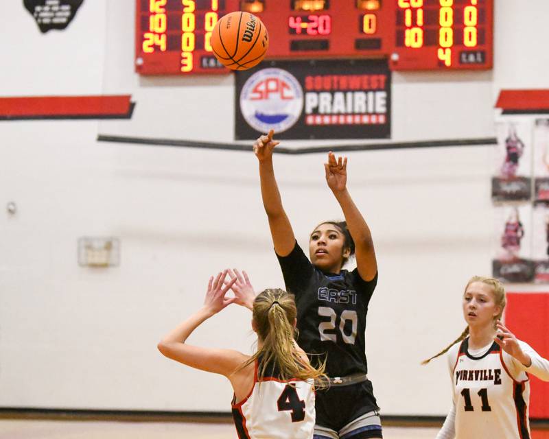 Oswego East's Jaliyah Shepard (20) takes a shot while being defended by Yorkville's Macie Jones (4) during the game on. Thursday Dec. 18, 2025, held at Yorkville High School.