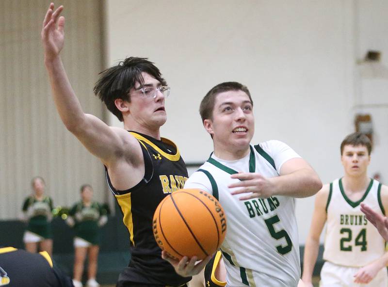 St. Bede's Halden Hueneburg eyes the hoop over Ashton-Franklin Center's Nate Becker during the Class 1A Regional quarterfinal game on Monday, Feb. 24, 2025 at St. Bede Academy.