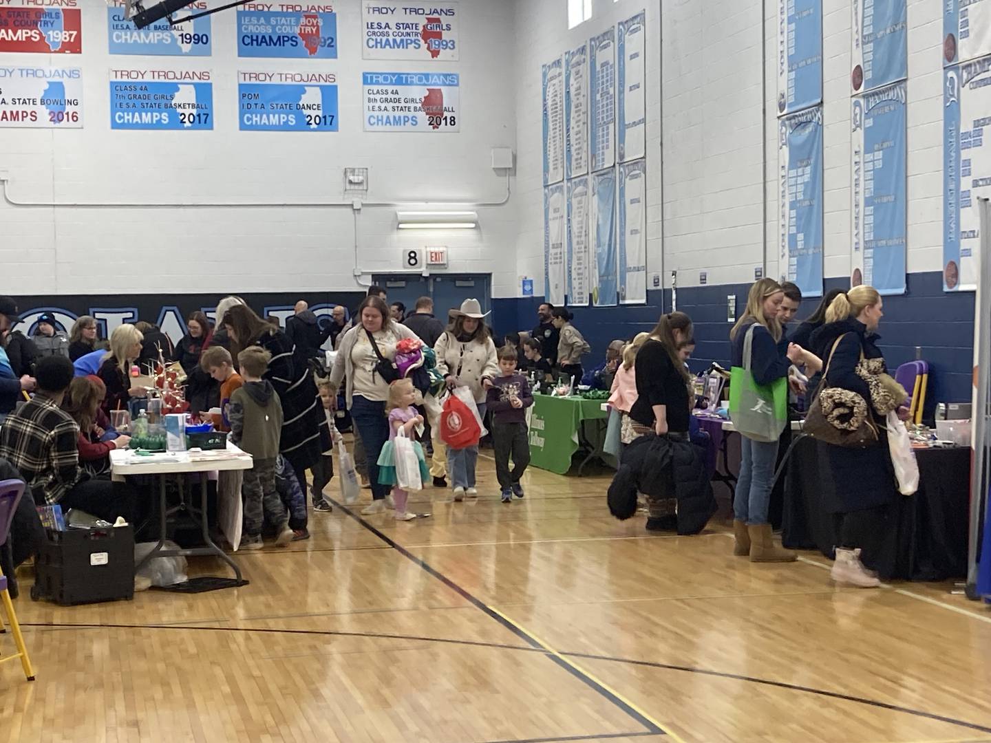 Families browse through vendors at the Will County Kids Fair at Troy Middle School in Plainfield on Monday, Feb. 17, 2025.