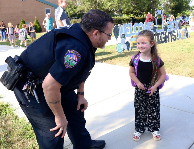 Officer Marty Sheets chats with Kindergartener Victoria Bates on her first day at Kaneland John Stewart Elementary in Elburn on Wednesday, Aug. 14, 2024.