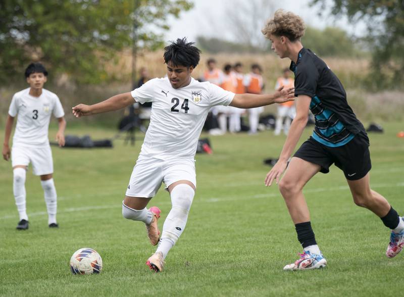 Harvard's Miguel Fuentes looks to pass as Woodstock North's Ethan Richardson defends during the Kishwaukee River Conference Tournament Championship game on Monday, October 6, 2025 at Woodstock North High School. Ryan Rayburn for Shaw Local