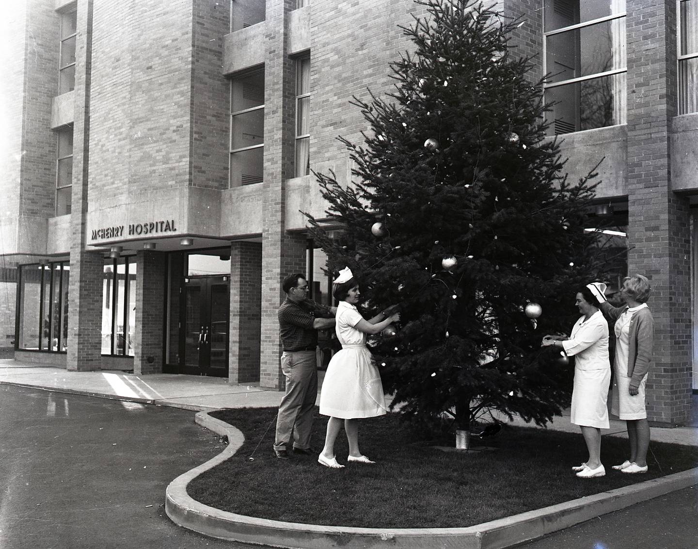 Staff decorate a Christmas tree outside McHenry Hospital in 1966.