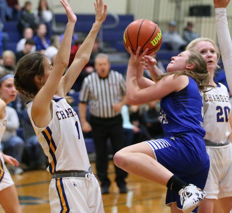 Newark's Peyton Wallin (33) runs into the lane to score a basket as Aurora Central Catholic's Sophie Reinbold (1) defends in the Tim Humes Breakout Tournament on Friday, Nov. 18, 2022 in Somonauk.