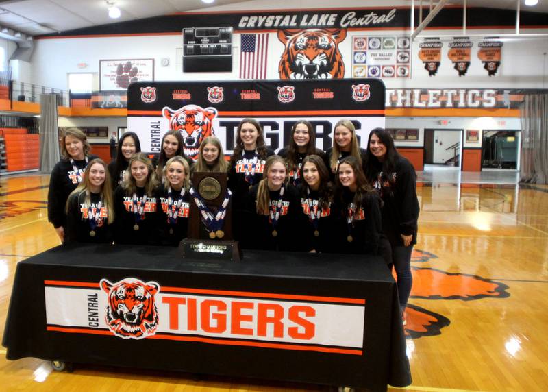 Team members pose for pictures as Crystal Lake Central held a celebration Sunday in their gymnasium after the Tigers on Saturday won the IHSA state title in Competitive Cheerleading-Medium Team at Grossinger Motors Arena in Bloomington.