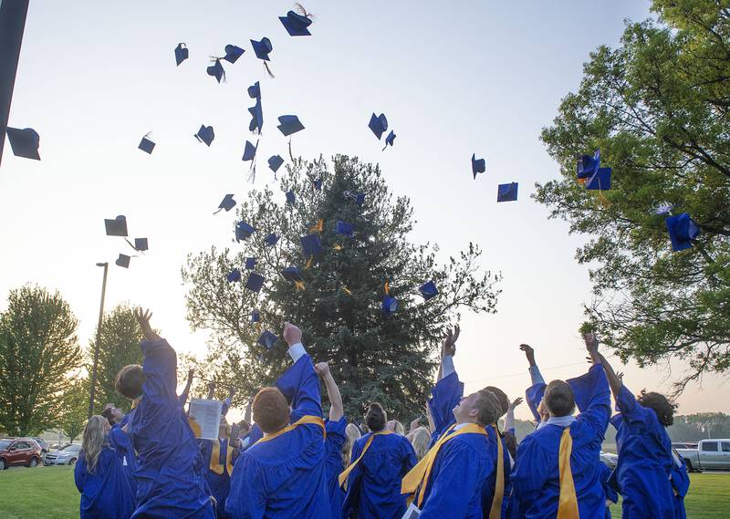 Newman 2022 graduates throw their hats into the air following their commencement Wednesday, May 18, 2022.