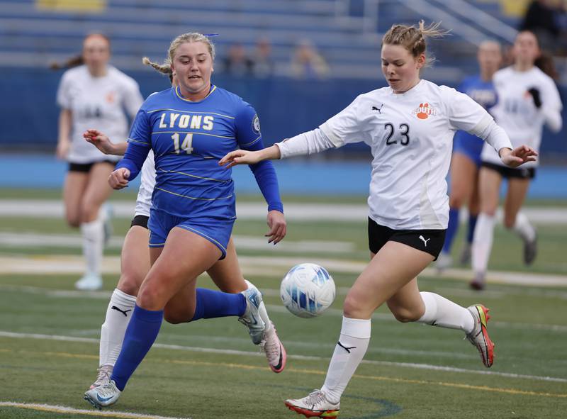 Wheaton Warrenville South's Delaney Miller (23) goes for the ball against against Lyons Township's Catie Brejcha (14) during the girl's varsity soccer match between Lyons Township and Wheaton Warrenville South high schools on Thursday, March 27, 2025 in Western Springs.