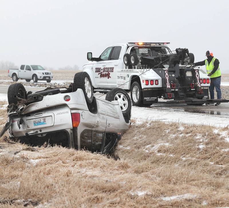 Workers from Tri-State Towing hook up a vehicle that slid off of the roadway and rolled over in the ditch Thursday, Feb. 16, 2023, on Perry Road near Howison Road just south of DeKalb. Winter weather resulted in several crashes in DeKalb County Thursday.