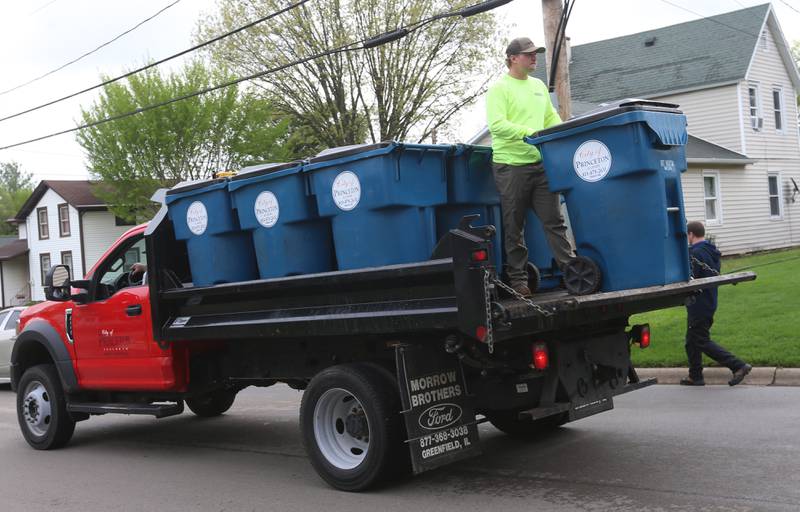 City of Princeton crews distribute new garbage totes along First Street on Monday, April 29, 2024 in Princeton.