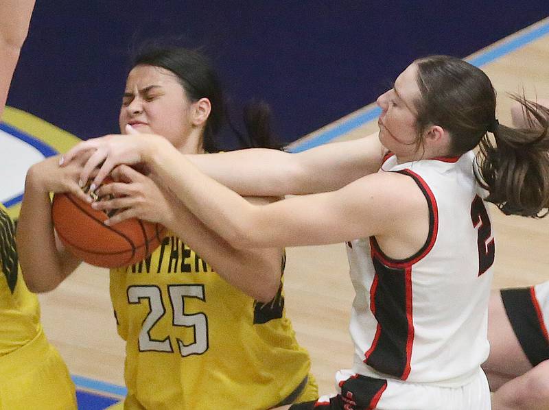 Putnam County's Esmeralda Avila forces a jump ball with Amboy's Kiera Karlson during the Class 1A Regional semifinal game on Monday, Feb. 12, 2024 at Marquette High School.