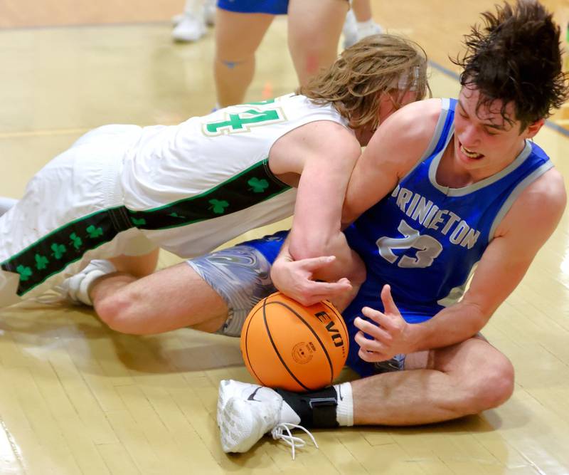 Princeton's Noah LaPorte and Seneca's Grant Siegel battle for a loss ball in Friday's regional finals at Prouty Gym. The Tigers won 59-53 to claim their fourth straight regional title.