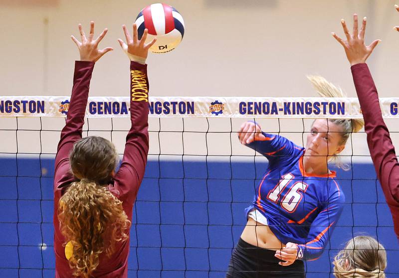 Genoa-Kingston's Alayna Pierce tries to spike the ball by a Montini blocker during their match Tuesday, Sep. 5, 2023, at Genoa-Kingston High School.