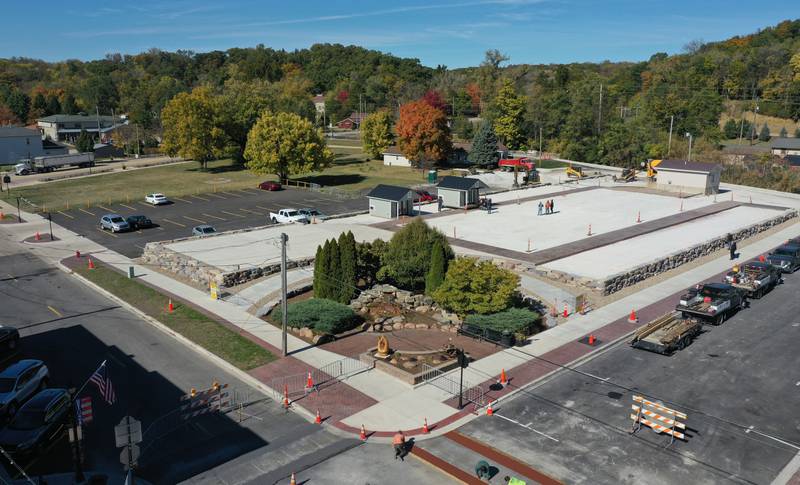 Crews move huts into the retail site plaza on Wednesday, Oct. 16, 2024 downtown Utica.