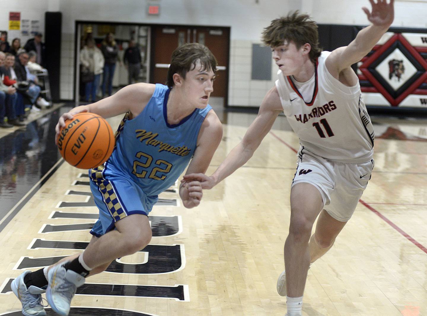 Marquette’s Rocky Haiduke tries to drive to the net past Woodland’s Nate Berry in the 1st period Friday at Woodland.