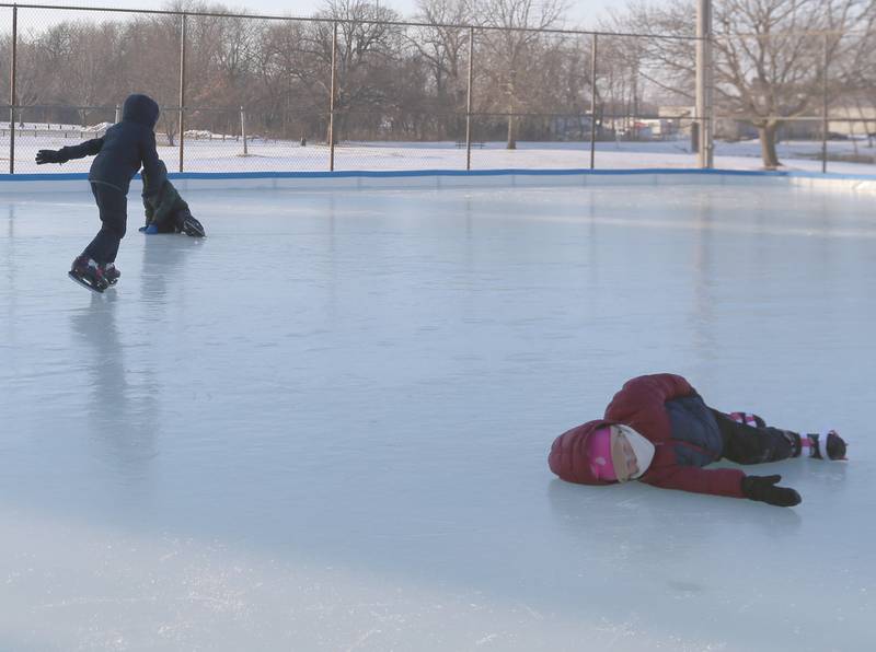 Hallie Gray of Princeton, enjoys laying on the ice while skating at Alexander Park on Thursday, Feb. 2, 2023 in Princeton.