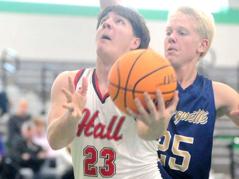 Hall's Aiden Redcliff shoots past Marquette's Luke McCullough on Thursday, Dec. 26, 2024, at Seneca High School.