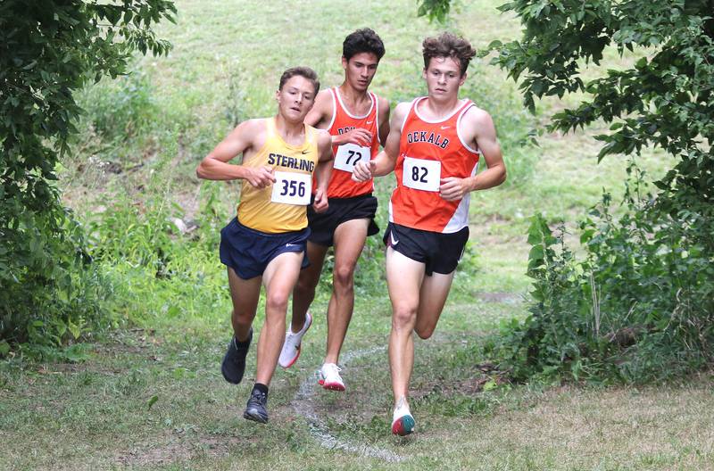 DeKalb's Alex Boyden (middle) and Riley Newport stay in a group with Sterling's Dale Johnson as they make a turn on the course Tuesday, Aug. 31, 2021 at the Sycamore Cross Country Invitational at Kishwaukee College in Malta.
