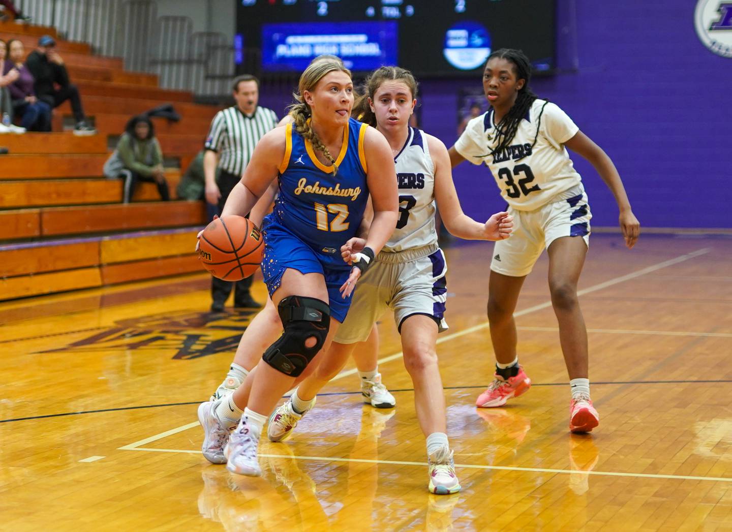 Johnsburg's Kaylee Fouke (12) drives to the basket against Plano's Josie Larson (23) during a basketball game at Plano High School on Tuesday, Jan 30, 2024.