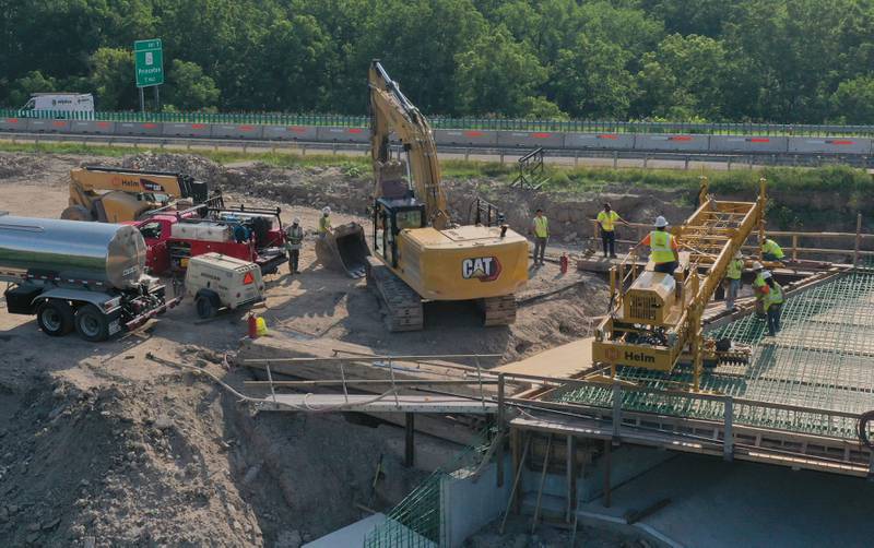 An aerial view of crews working on the Interstate 180 bridge crossing over the Tiskilwa Bottom Road on Tuesday, July 8, 2025 near Tiskilwa. The Illinois Department of Transportation continues to work on the 180 bridges over Bureau Creek and Tiskilwa Bottom Road.  The I-180 work zone is a mile south of the Route 26 interchange. Both the south and northbound bridges are being replaced. Girders have been installed on the bridge. Tiskilwa Bottom Road remains closed under I-180 during the project and traffic should follow the posted detour signs. The 24.2 million project is scheduled to be completed by the end of 2026.