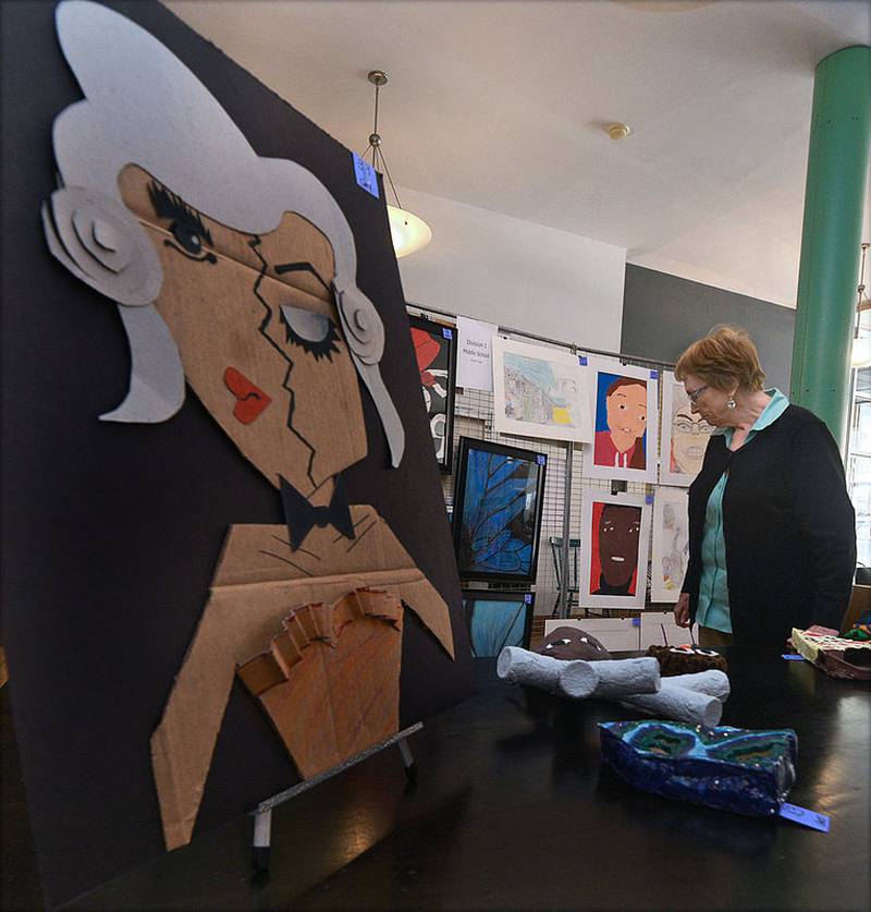 The 27th Annual Town & Country Youth Art Show took place Saturday at Jeremiah Joe Coffee in Ottawa. Darlene Spelich, of the Ottawa Art League, which sponsored the event, looks over some of the art displayed. The show had 193 entries with 135 students participating from La Salle and Grundy counties — 11 prizes were awarded.