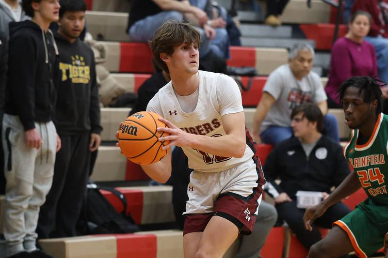 Plainfield North’s Ryan Barriball looks to pass after a turnover against Plainfield East on Tuesday, Dec. 9, 2025 in Plainfield.
