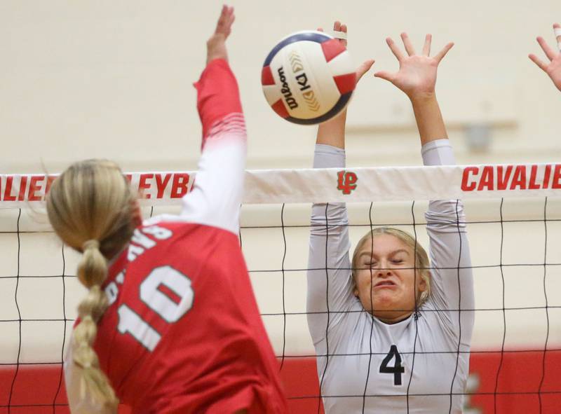 Kaneland's Mylee Crosby blocks a spike from L-P's Kelsey Frederick on Tuesday, Oct. 7, 2025 in Sellett Gymnasium at L-P High School.