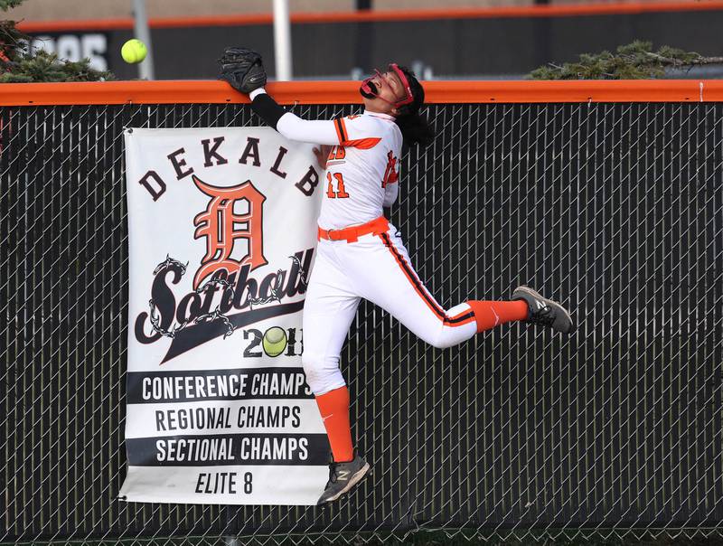 DeKalb's Sydney Myles can’t quiet make the catch on a Naperville Central home run Wednesday, April 16, 2025, during their game at DeKalb High School.