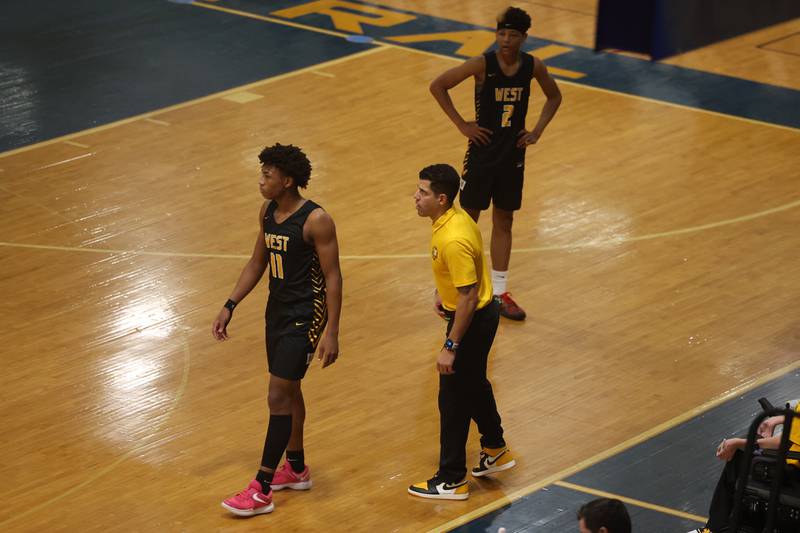 Joliet West head coach Jeremy Kreiger talks with Jeremy Fears as play gets ready to resume against Joliet Central.