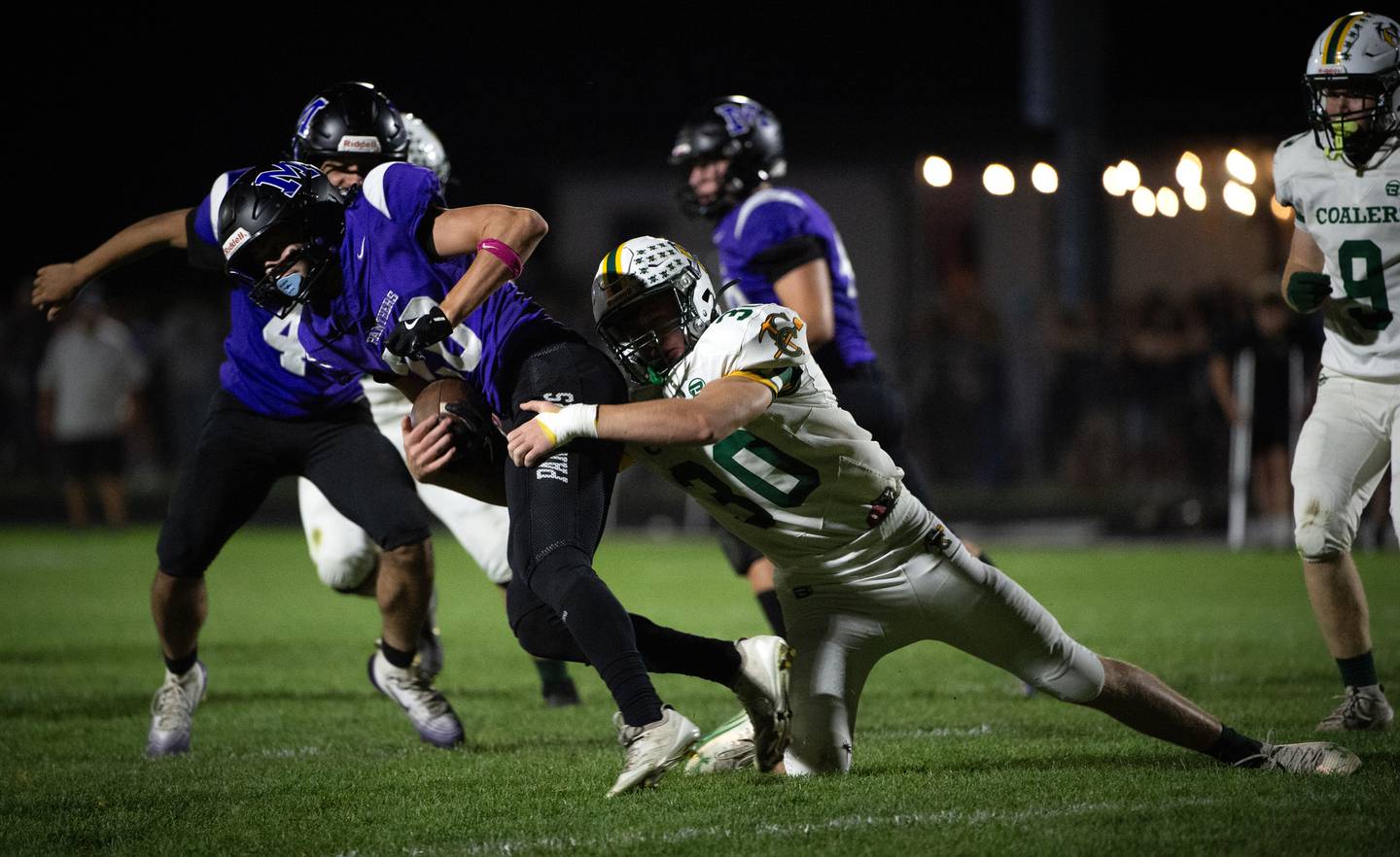 Manteno's Briggs Cann carries the ball as Coal City's AJ McGarvey, right, snags him in a game on Friday, October 3, 2025.
