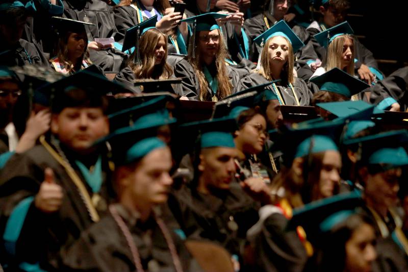 Members of the Class of 2025 wait in the auditorium before lining up for graduation at Woodstock North High School in Woodstock on Saturday, May 17, 2025.