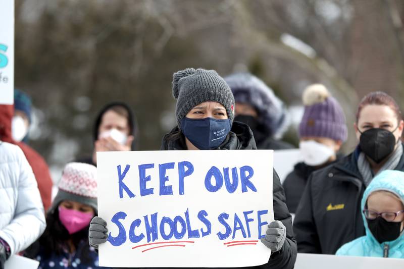 Shannon Limjuco, parent of a fifth-grader and second-grader in Community Unit School District 200, rallies in favor of requiring masks in schools outside the district’s headquarters in Wheaton on Monday, Feb. 7, 2022.