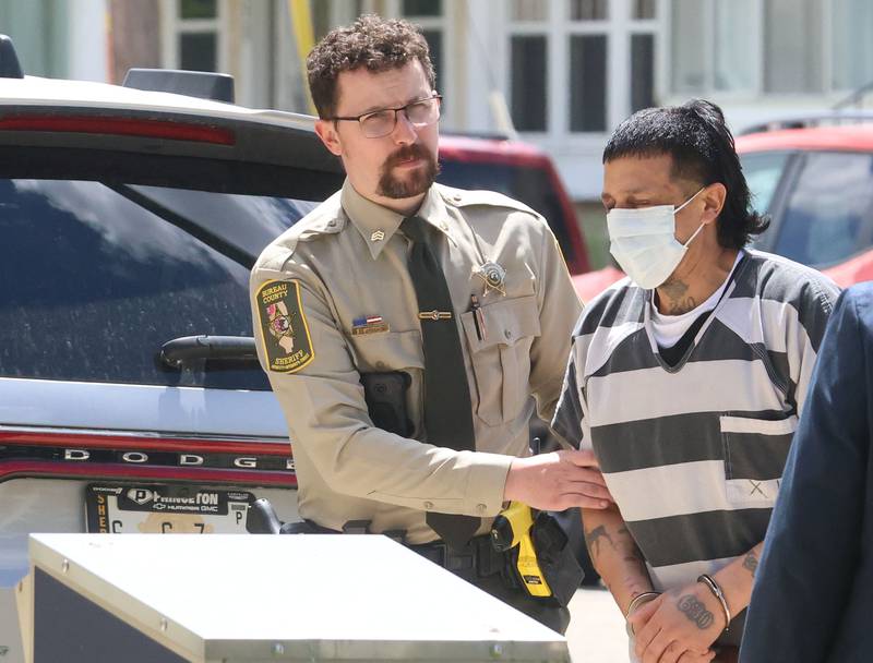 Anthony Daniel Rodriguez (center) walks into the Bureau County Courthouse for an appearance while being escorted by Bureau County correction sergeant Ethan Wright and Bureau County Sheriff Jim Reed. Rodriguez, a 42-year-old man has been charged in connection with a shooting near DePue that killed a 3-year-old child during a domestic disturbance Sunday.
