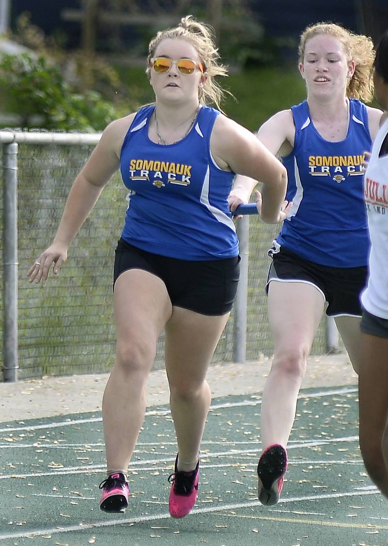Somonauk’s Myranda Banister and Kelsey Knauf competes in the 4x100 meter relay during the Class 1A girls Sectional track meet on Thursday, May 11, 2023 at Seneca High School.