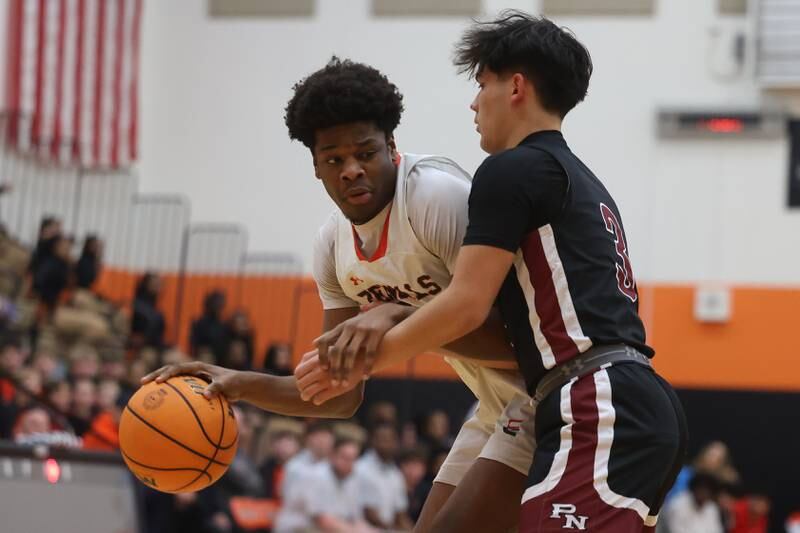 Plainfield East’s Leslie Nii Apa Pobee works inside the paint against Plainfield North on Tuesday, Jan 14, 2025.