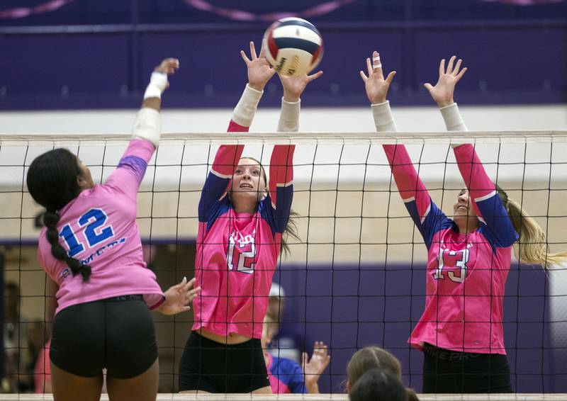 Dixon’s Izzy Queckboerner (left) and Solis Thompson against go for a block against Newman’s Gisselle Martin Thursday, Oct. 2, 2025.