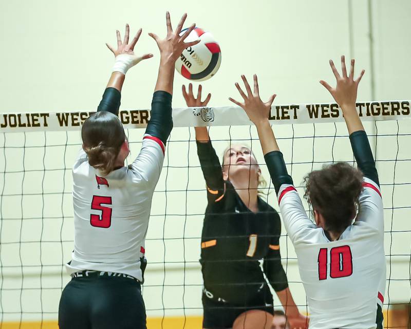 Joliet West's Ava Grevengoed (1) tips the ball over the net during regional final volleyball match between Bolingbrook at Joliet West.  Oct 26, 2023.