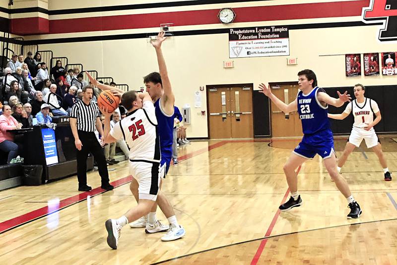 Newman's Asher Ernst uses his 6'4" frame to try and keep EP’s Derek Naftzger from passing the ball Wednesday. The Comets traveled to Prophetstown for the conference game, holding onto their undefeated status this season, winning 57-49