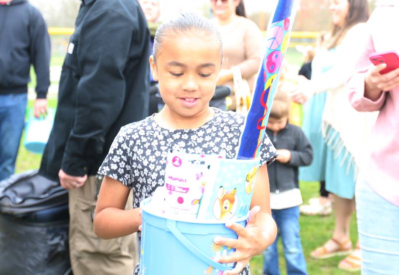 Layla Warren of La Salle, smiles after receiving her Easter basket prize during the annual Easter egg hunt on Saturday, April 19, 225 at Carey Memorial Park in Utica.