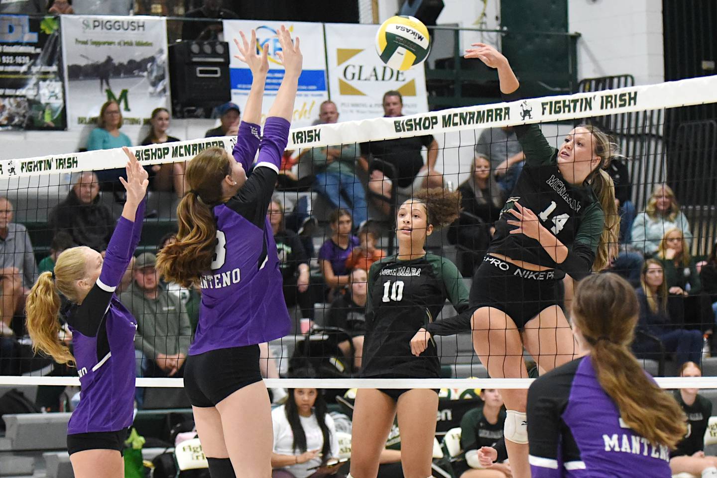 Bishop McNamara's Kate Dole, right, sends a hit over the net during a home game against Manteno Monday, Oct. 20, 2025.