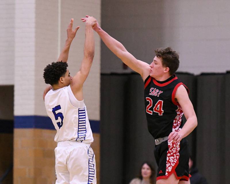 Riverside-Brookfield's Cameron Mercer (5) takes a shot while being defended by Glenbard East's Sam Walton (24) during the game on Tuesday Feb. 3, 2026, held at Riverside-Brookfield High School.