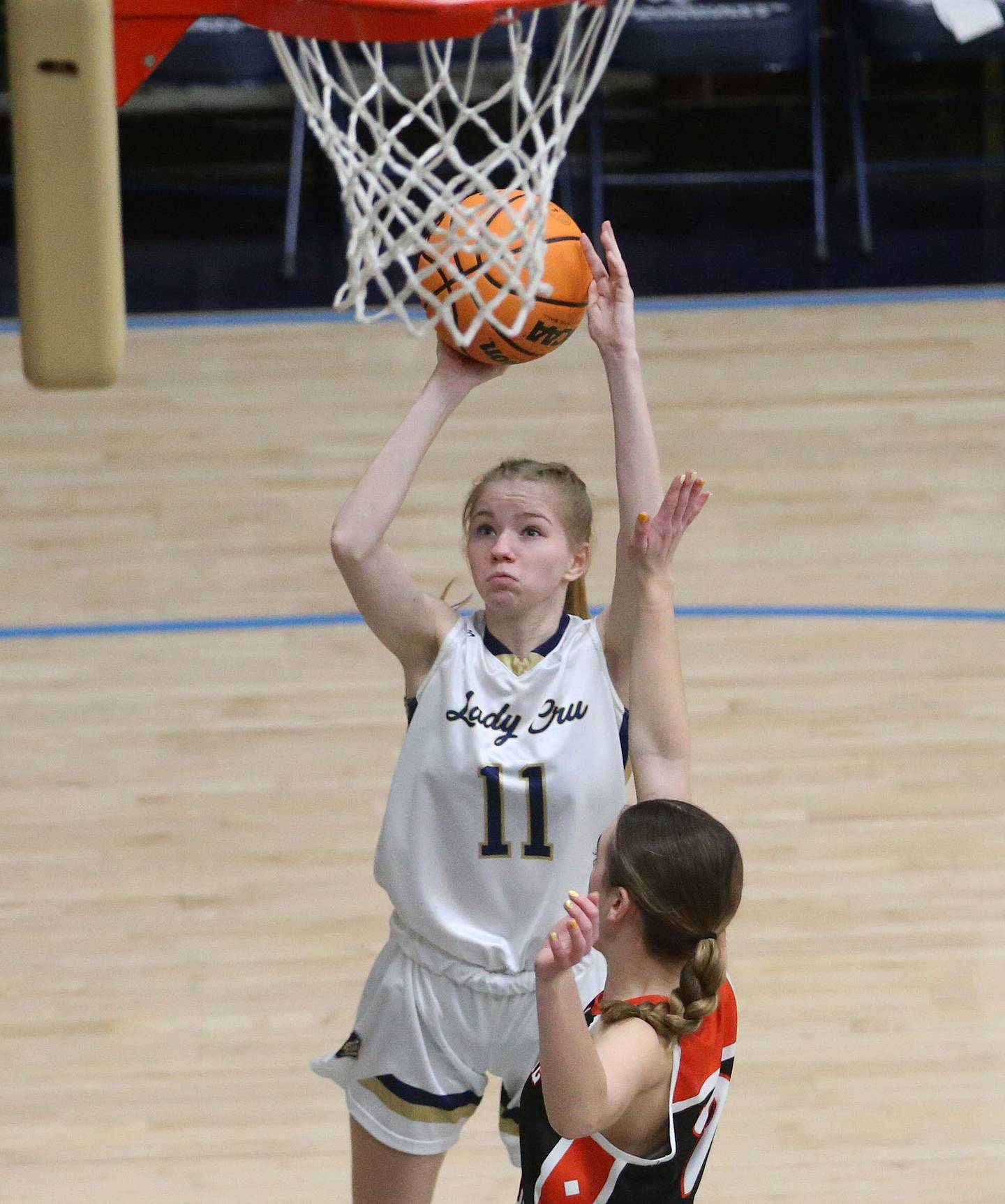 Marquette's Keely Nelson takes a jump shot near the hoop over Roanoke-Benson's Elly Heineke on Thursday, Feb. 6, 2025 in Bader Gym at Marquette High School.