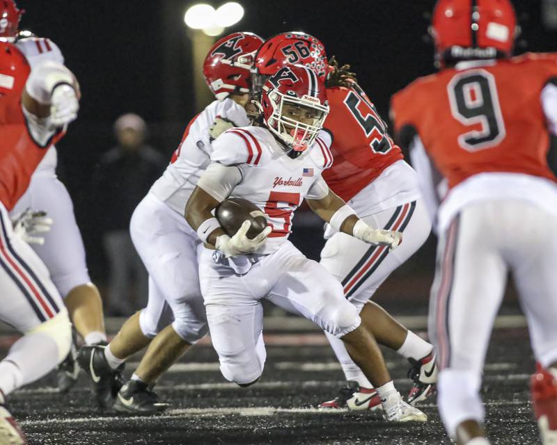 Yorkville's T.J. Harland (5) makes a move in the hole during football game between Yorkville at Bolingbrook Friday, Oct 24, 2025 in Bolingbrook.