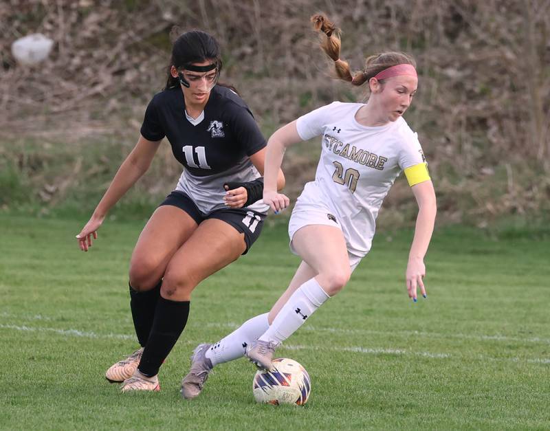 Sycamore's Cortni Kruizenga turns the ball away from Kaneland's Corinne Faivre during their game Monday, April 13, 2026, at Kaneland High School.